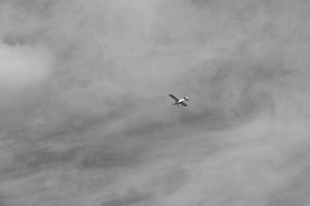 small plane doing pirouettes in the cloudy sky