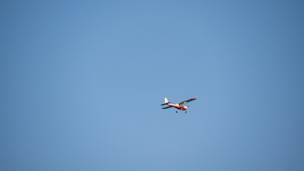 small plane flying in a blue sky