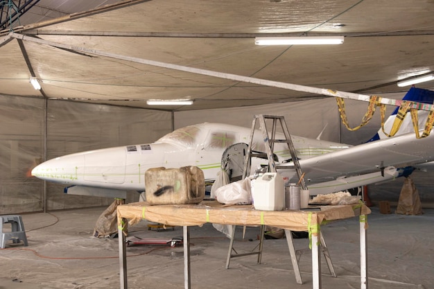 A small plane that is drying after being painted