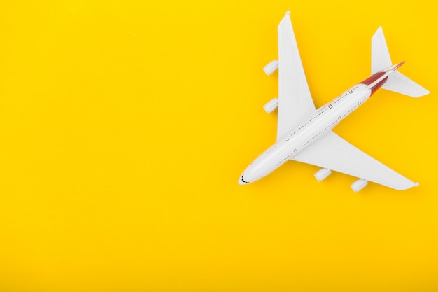 Small plane on the yellow background.