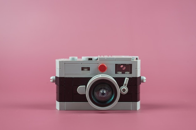 small plastic camera on pink background