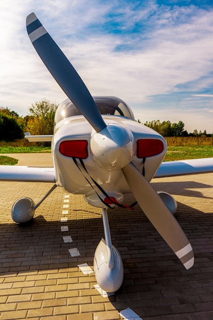 Small private white plane before the flight. Front view. Close-up.