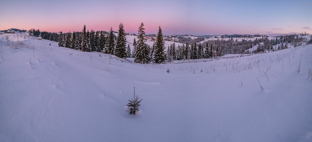 Small and quiet alpine village and winter sunrise snowy mountains around Voronenko Carpathian Ukraine