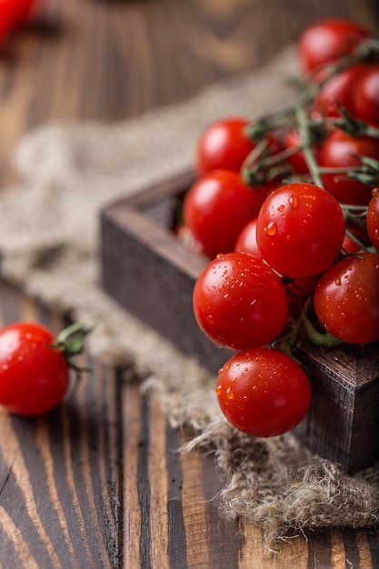 Small red cherry tomatoes. Cherry tomatoes on a branch