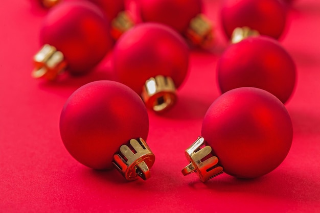 Small red christmas balls on red background