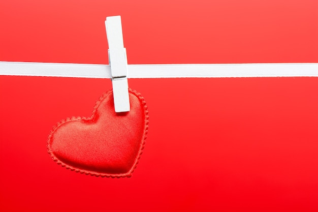 Small red heart hanging on the ribbon