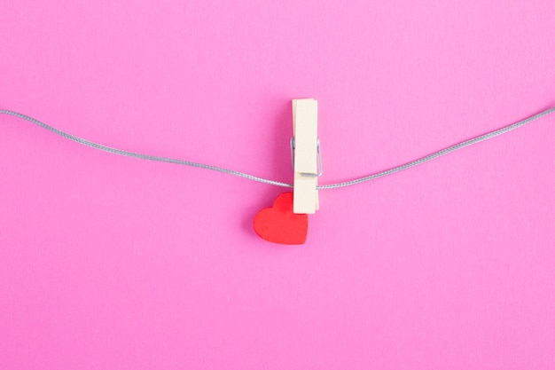 Small red heart on wooden clothespin