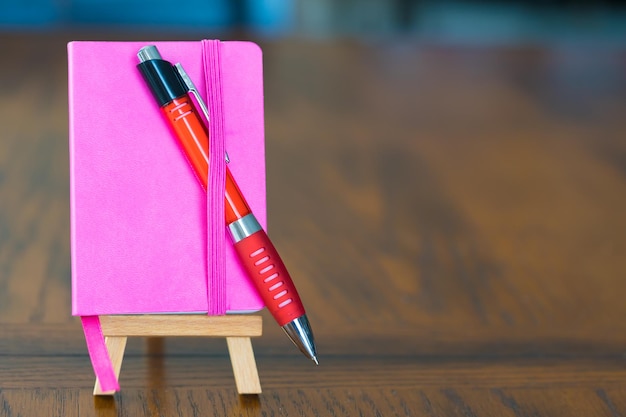 Small red notebook on easel stand