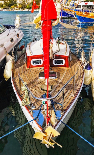 Small red sail yacht in marina smile