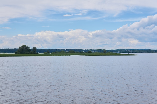 Small reed island in the middle of a wide river