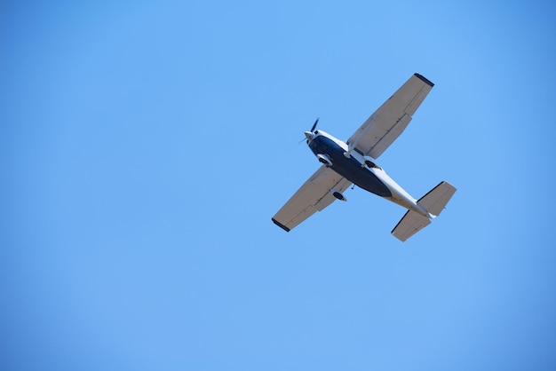 small retro airplane, clear blue sky in background