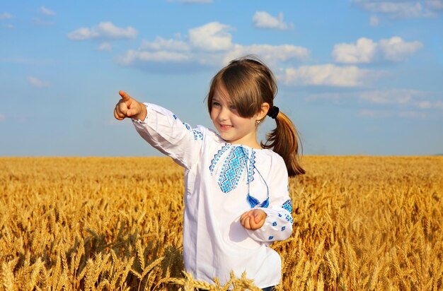 Фото Маленькая сельская девушка на пшеничном поле