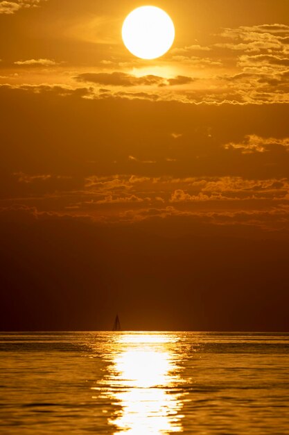 Small sailboat at sunset