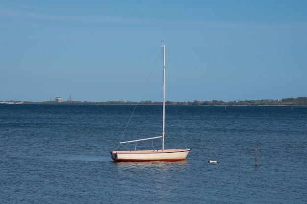 Small sailboat in the water near the coast of Denmark