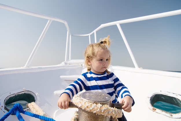 Small sailor on boat summer vacation childhood happiness funny
kid in striped marine shirt journey discovery transportation happy
small boy on yacht sea trip concept boat trip sailing boat