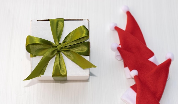 small santa hat isolated on light background.measure tape,white gift box,christmas mood