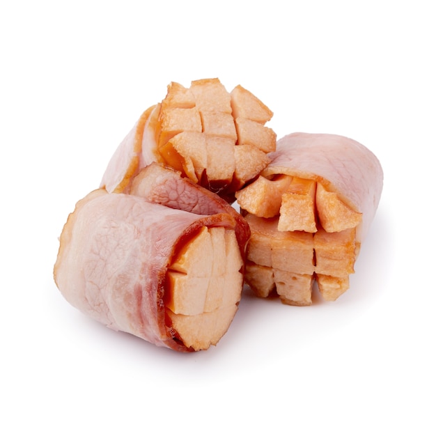 Small sausages wrapped in a blanket of smoked streaky bacon isolated on white background