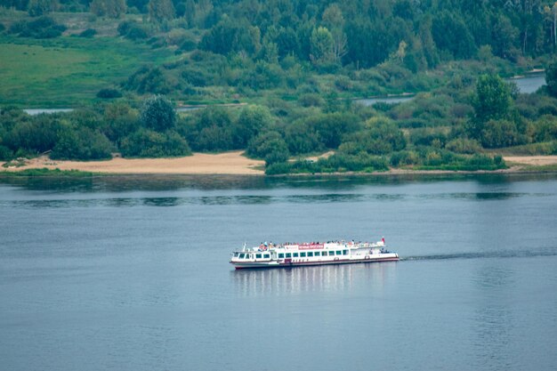 A small ship sails along the Volga River