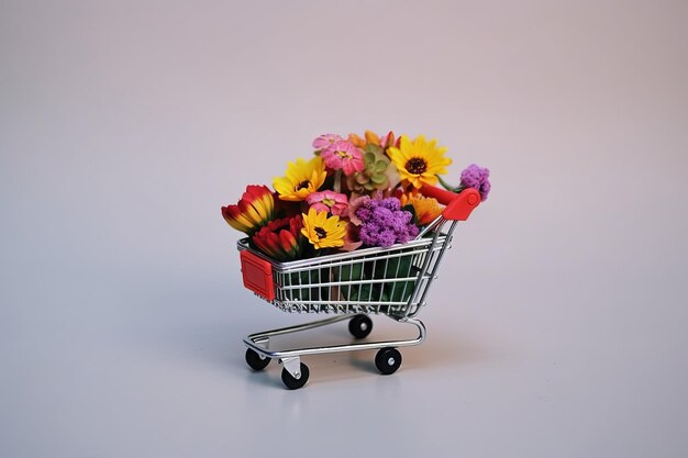 A small shopping cart with flowers in it