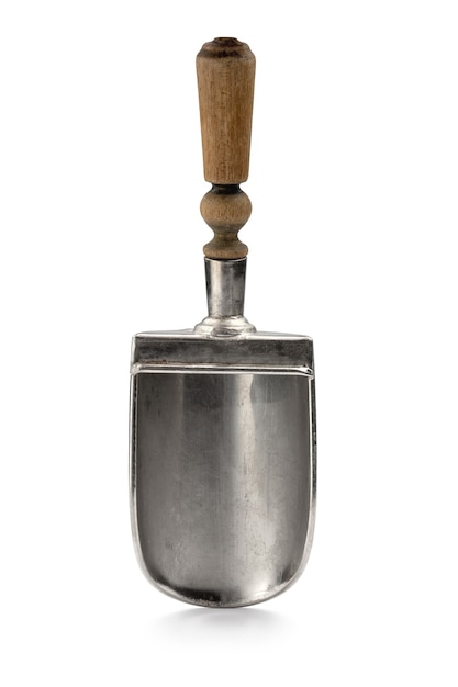 a small shovel made of white metal with a wooden handle antique work
