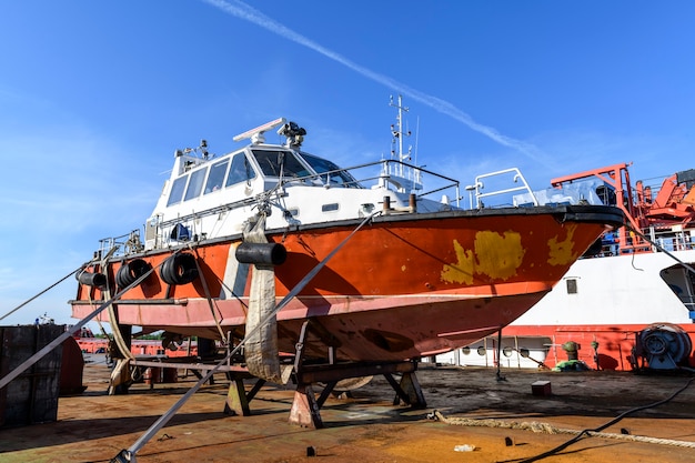 Small sized vessel ashore on ship repairing yard