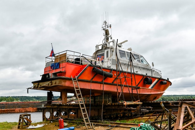 Small sized vessel ashore on ship repairing yard