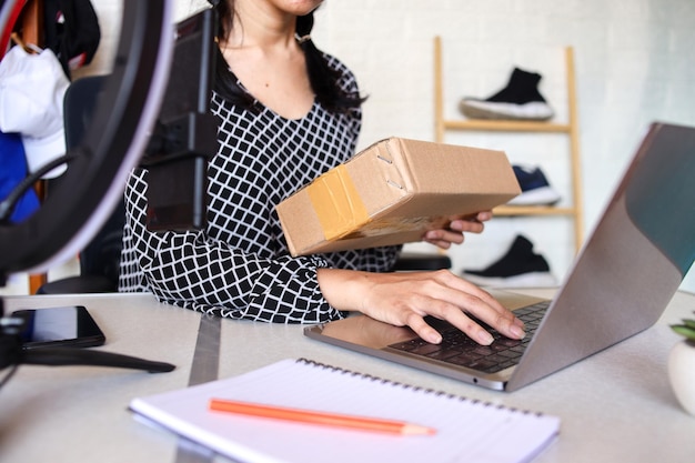 Small startup business owners using computers at work checking production orders