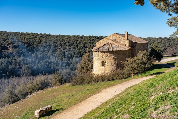 Small stone house in the forest next to a dirt road near the medieval village of Pedraza Segovia