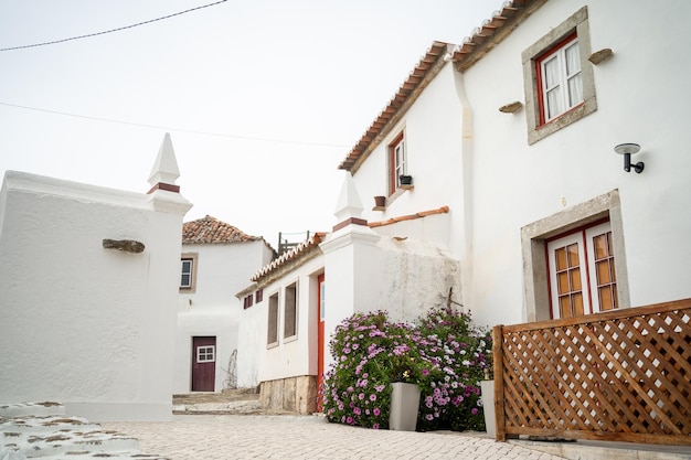 Small streets in portugal surrounded by white twostorey houses