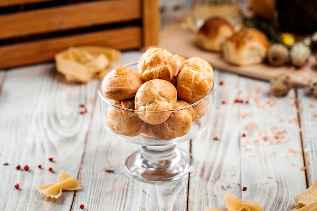 Small sweet dessert profiteroles in a glass