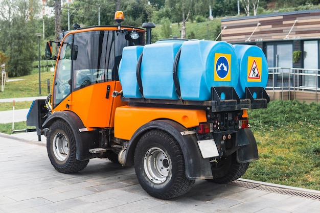 small tank truck for cleaning paths and watering plants in the city park