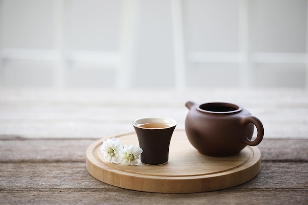 Small tea cup and earthenware teapot