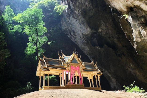 A small temple in a cave with a large cave in the background.