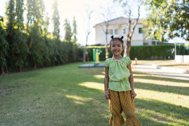 Photo small thai girl smiling at park.