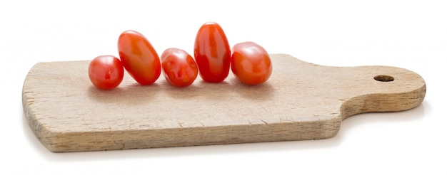 Small tomatoes on a wooden cutting board