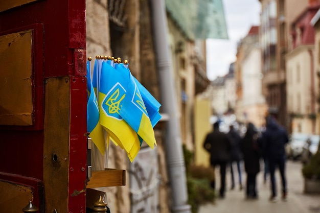 Small Ukrainian flags in city building Lviv during war