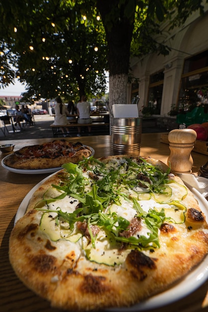 ストリート カフェのテーブルに小さなベジタリアン ピザ