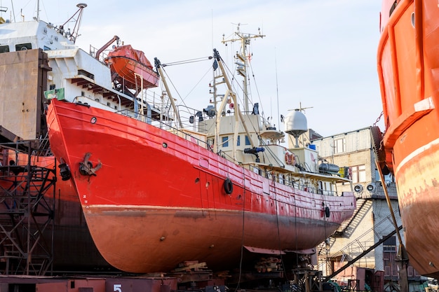 Small vessel ashore on ship repairing yard