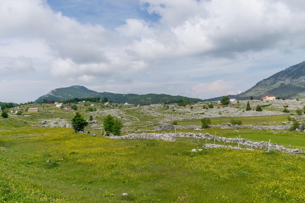 A small village is situated among many hills and mountains