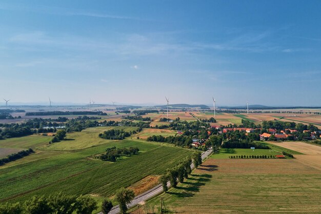 Small village near wind turbine generator aerial view