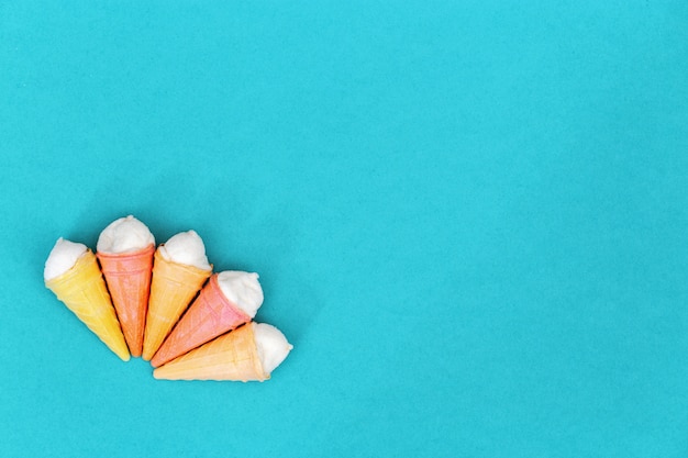 Small waffle cones with ice cream on paper. Minimal concept.