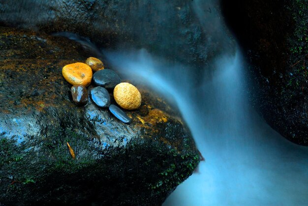 Small waterfall and rounded pebbles in a stream