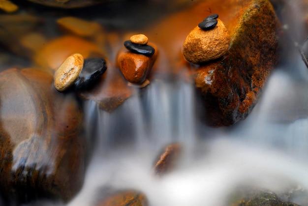 Small waterfall and rounded pebbles in a stream