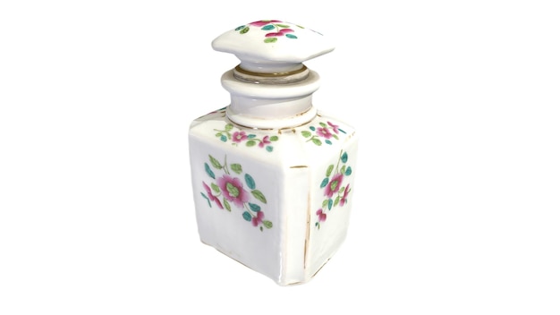 A small white ceramic bottle with flowers on the front.