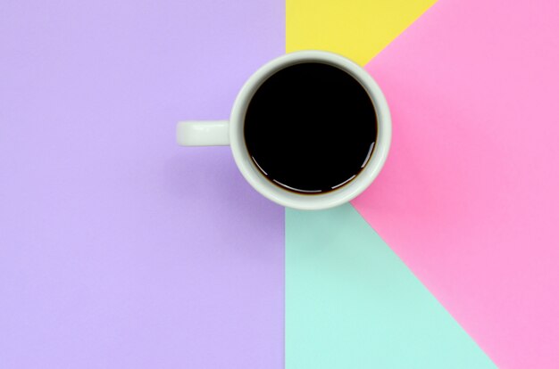 Small white coffee cup on texture background