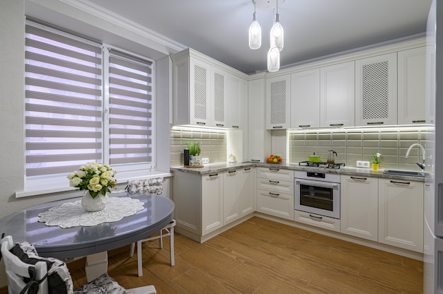 Small white cozy and comfy contemporary classic kitchen interior with wooden furniture