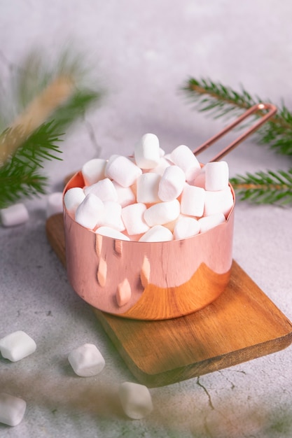 Small white marshmallows in pink metal saucepan