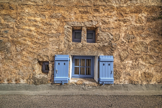 Small windows in a rustic wall in Sardinia Italy