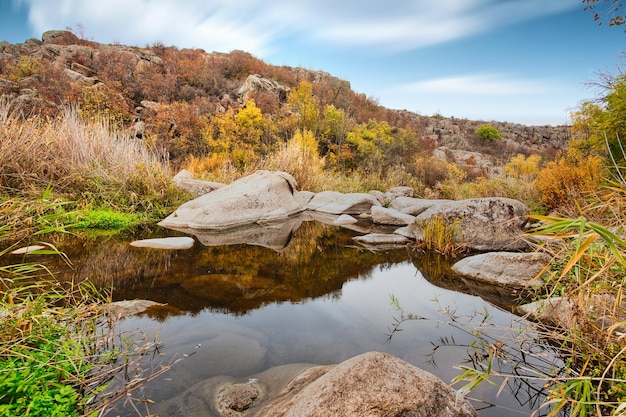 A small wonderful lake along a picturesque river flowing through a beautiful canyon Huge hatches are in the water Ukraine