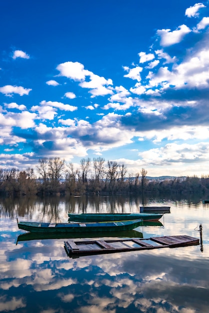 Small wooden boats on the calm lake